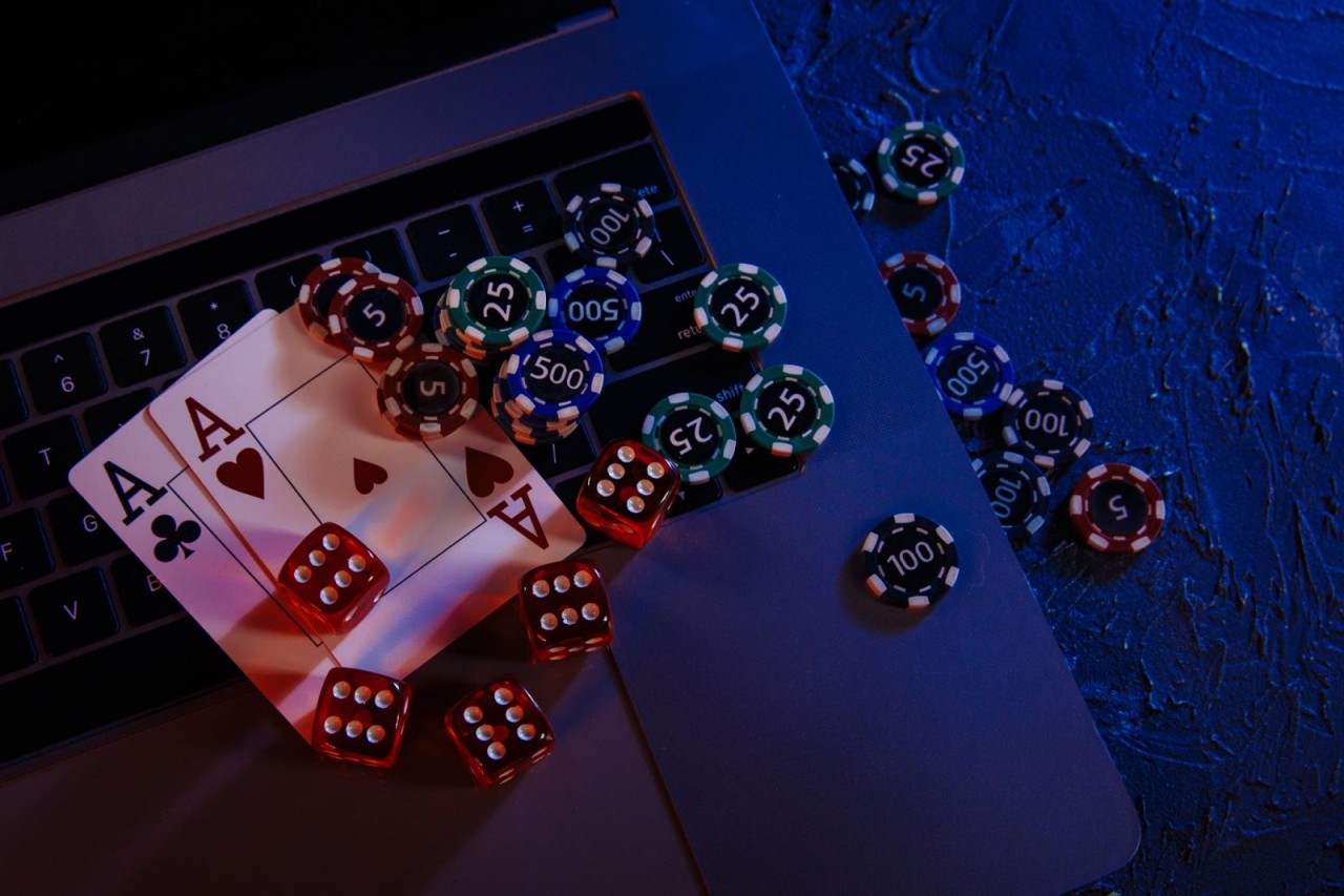 casino-play-online-concept-playing-chips-cards-dices-laptop-s-keyboard-min